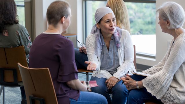 Women speaking candidly at a support group for people with breast cancer.
