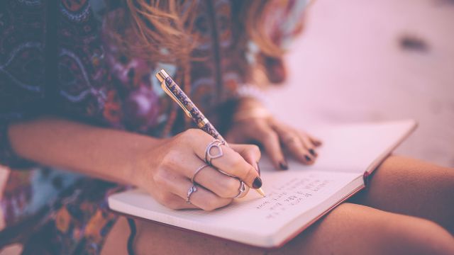 woman writing in journal