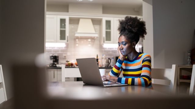 A woman researches what lupus is on her laptop. She sees signs of lupus on her daughter, like a butterfly-shaped lupus rash. 