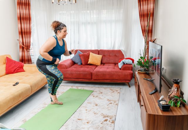 woman exercising in front of TV