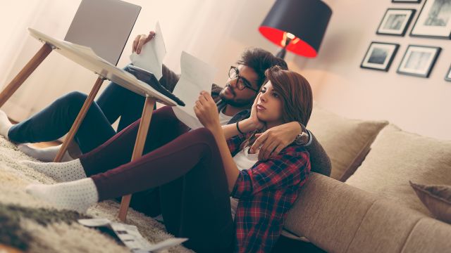 Frustrated couple checking their bills