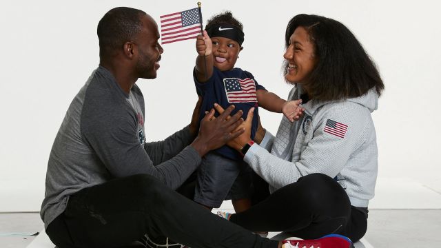Elana Meyers Taylor and her family dressed in US Olympic gear and waving the US flag.