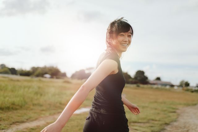 woman walking backwards outdoors