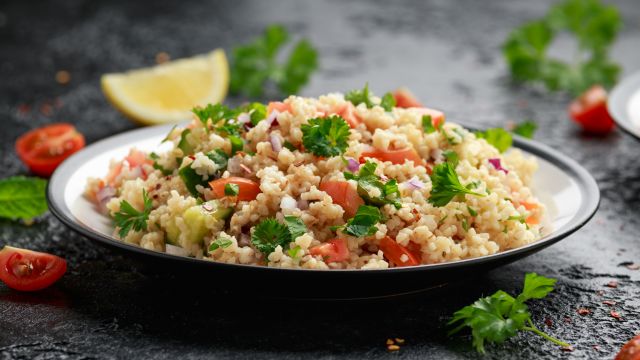 a plate of tabbouleh (bulgur salad) with seasonings and vegetables