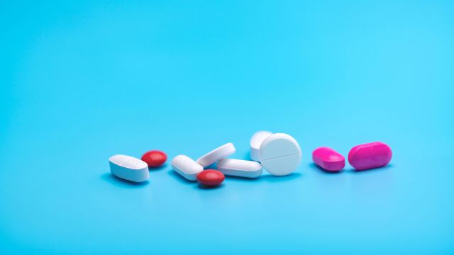 Various medications on a blue background.