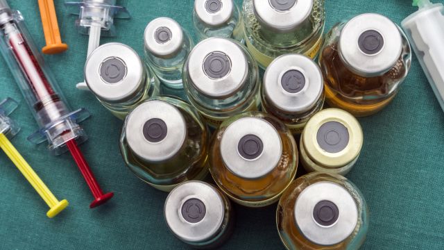 A collection of medication vials and syringes. Immunotherapies for NSCLC are given with an intravenous infusion.