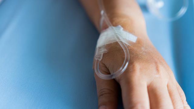 A person with kidney cancer receives an immunotherapy drug with an IV.
