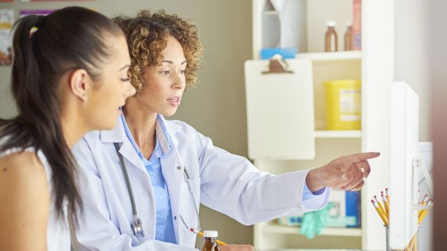 Young woman with dermatologist