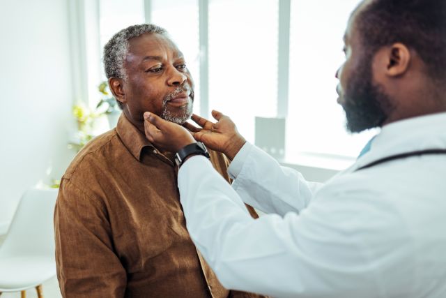 a Black doctor provides a physical examination to a Black patient