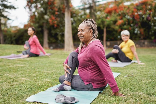 mature women doing outdoor yoga