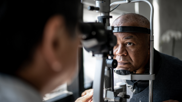 Ophthalmologist examining the eyes of a mature man with cataracts