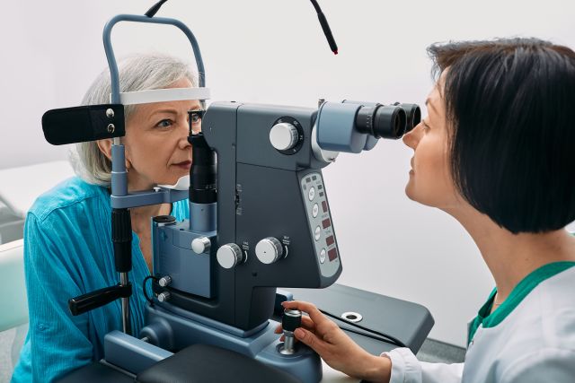 view of senior woman getting an eye exam with an ophthalmologist