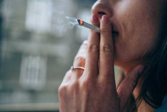 closeup of a woman smoking a cigarette