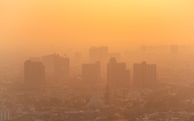 city scape shrouded in orange haze due to pollution and poor air quality