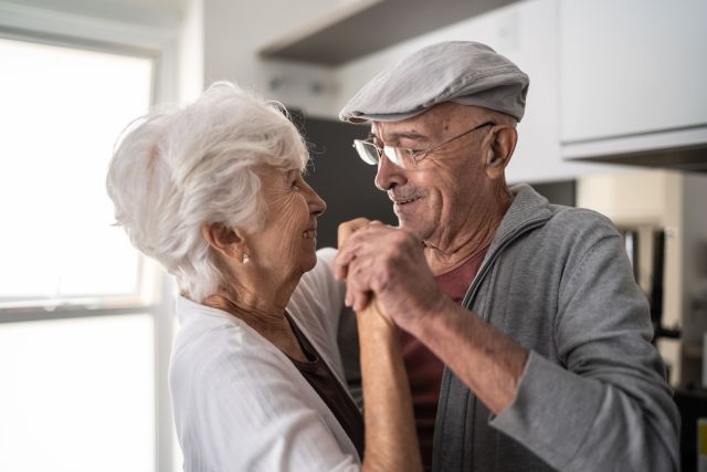 Older man and woman dancing, view from the side