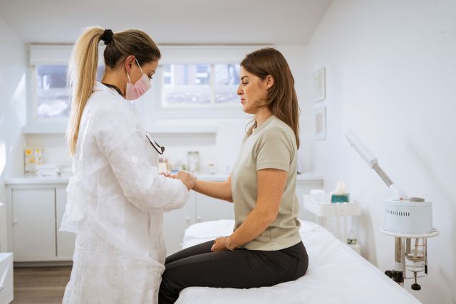 Female doctor performing a physical examination on the client