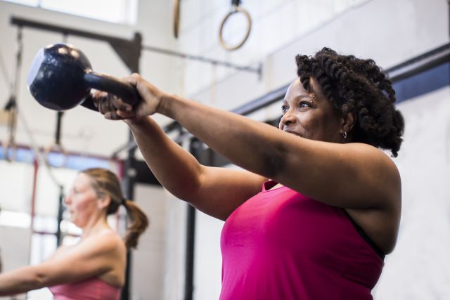 40-year-old woman strength training with a kettle bell