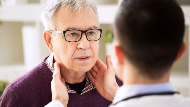 Doctor checking glands for potential signs of waldenstrom macroglobulinemia (WM).