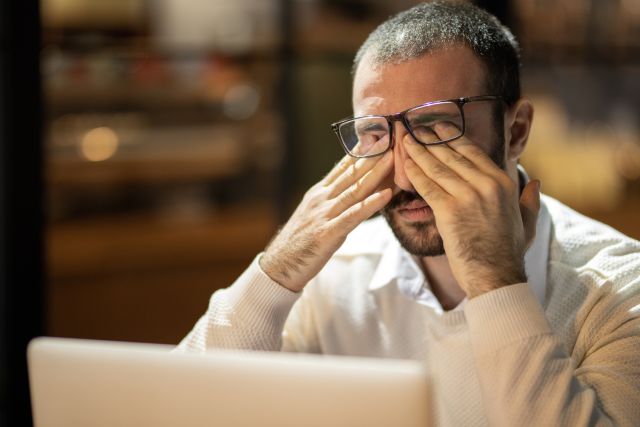 A man rubs his eyes trying to relieve the itch and discomfort of dry eye. In addition to eye drops, there are several other treatments for dry eye syndrome.