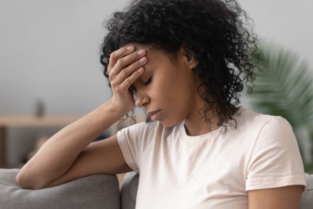 Black adult woman looking stressed and tired
