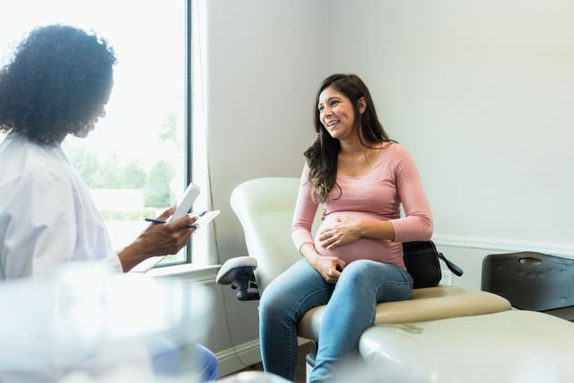 pregnant woman talking to obgyn