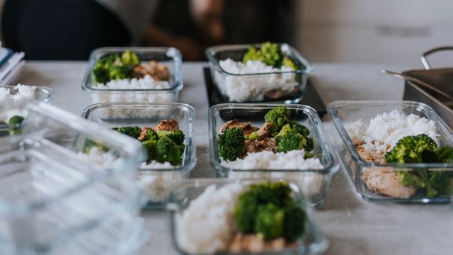 A woman portions out several days worth of diabetes-friendly meals in glass containers.