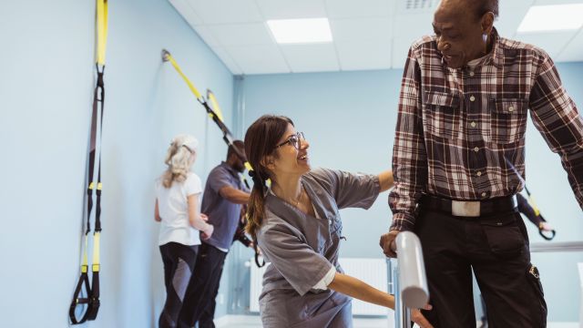 A senior man works with a physical therapist. Physical therapy can be an important part of treatment for people living with Parkinson's disease.