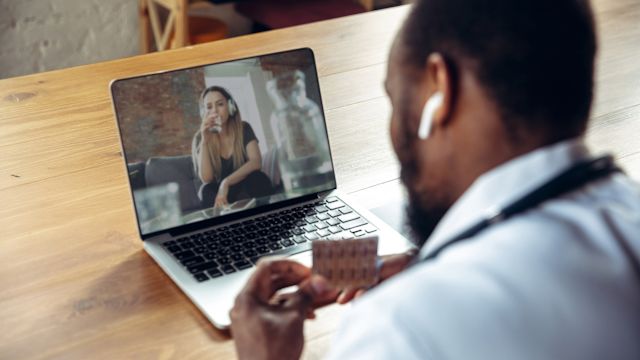 A person being treated for hepatitis C checks in with their healthcare provider during a video call.