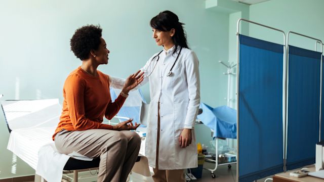 A young woman discusses treatment for a thyroid disorder with her endocrinologist.