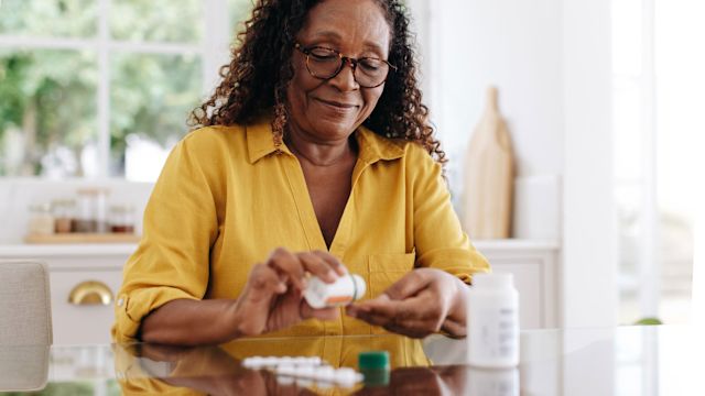 mature woman with diabetes takes a heart medication