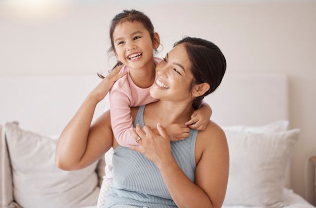 A young happy Latina mother and her child smile as they enjoy their safe home that is free of toxic chemicals