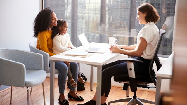 A young mom and her 7-year-old daughter speak with their healthcare provider during an appointment to discuss primary immunodeficiency management.