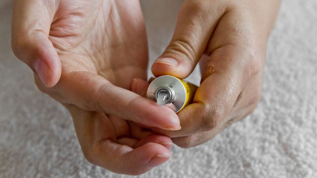 Person squeezing ointment into hand