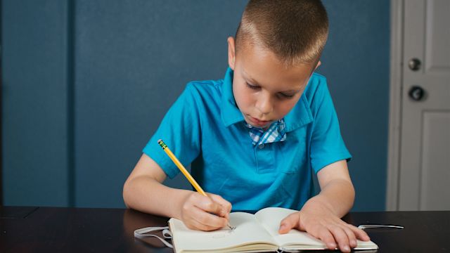 First grade student journaling