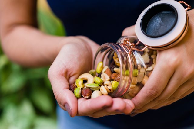 woman pouring nuts into her hand