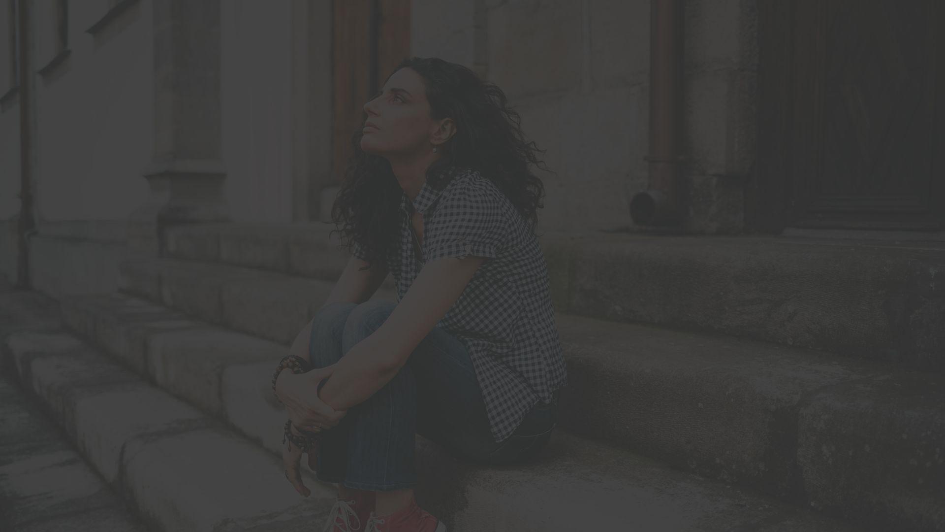 young woman sitting on stairs