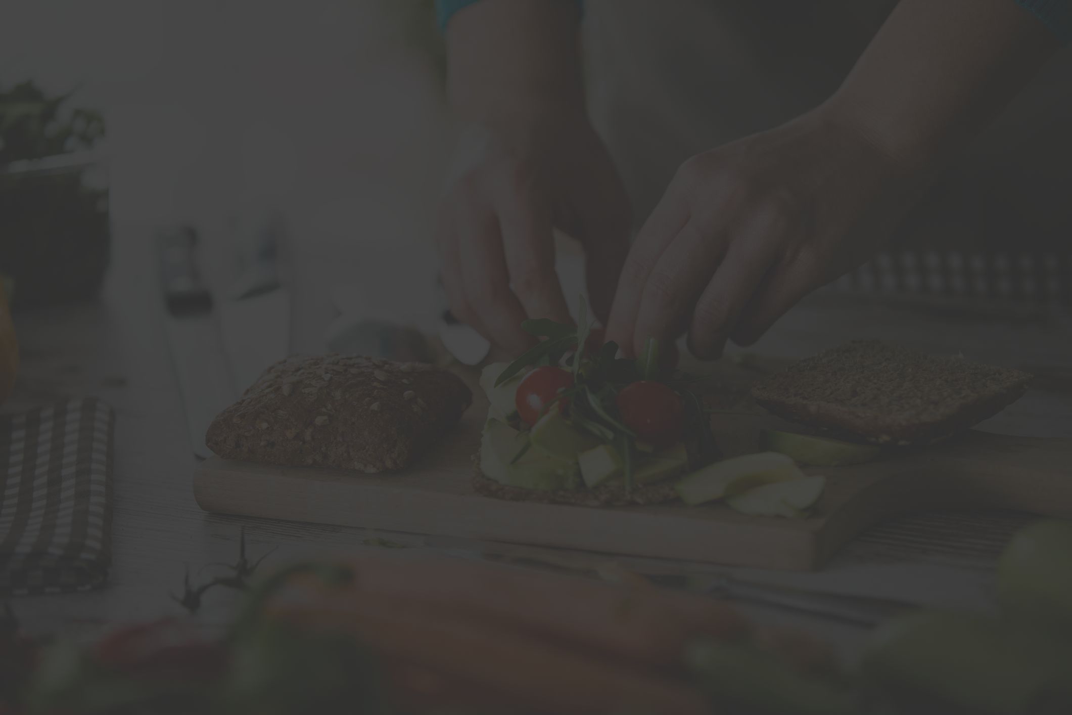 man preparing a healthy vegetable sandwich in kitchen