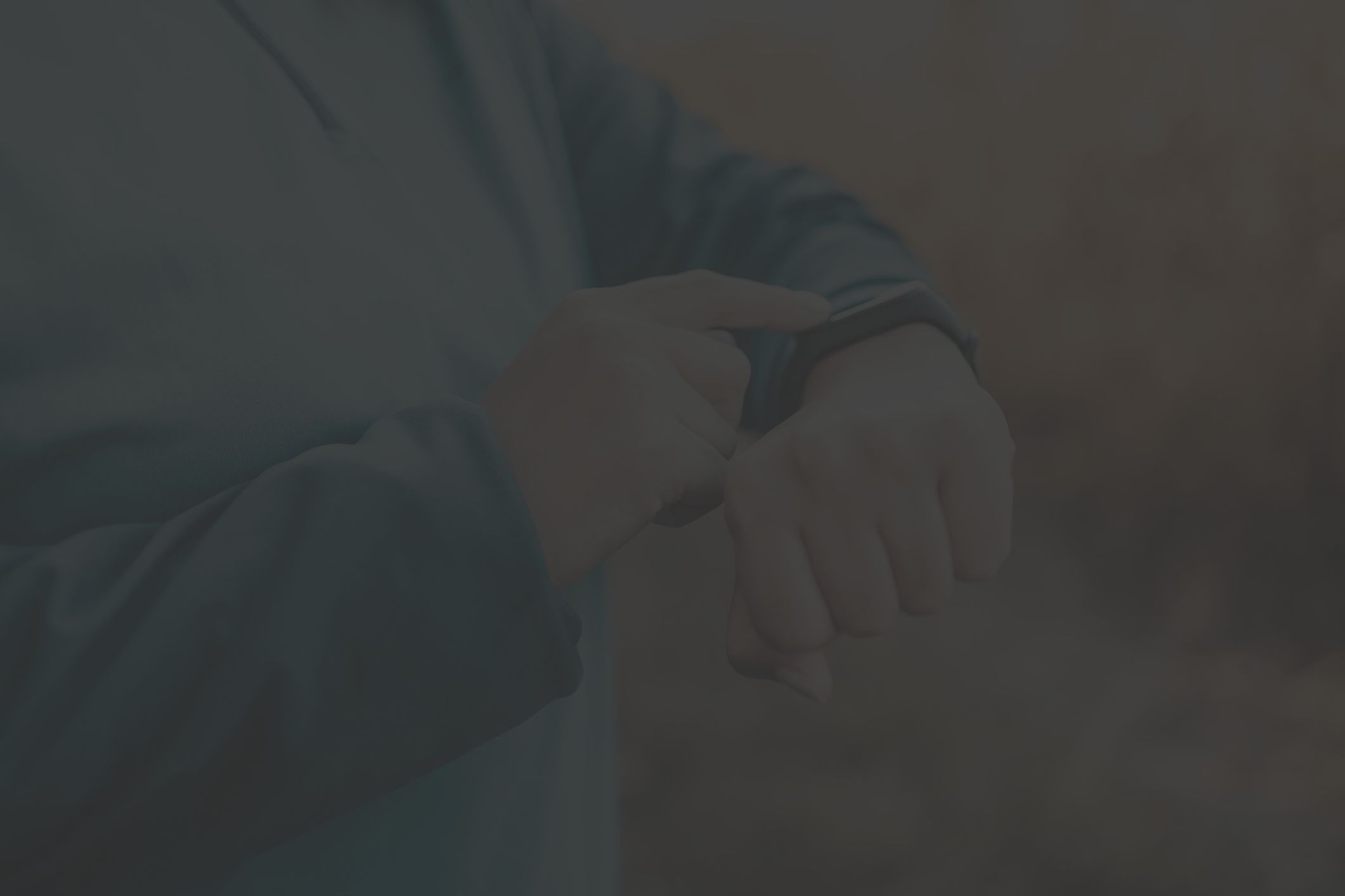 person looks at their smartwatch