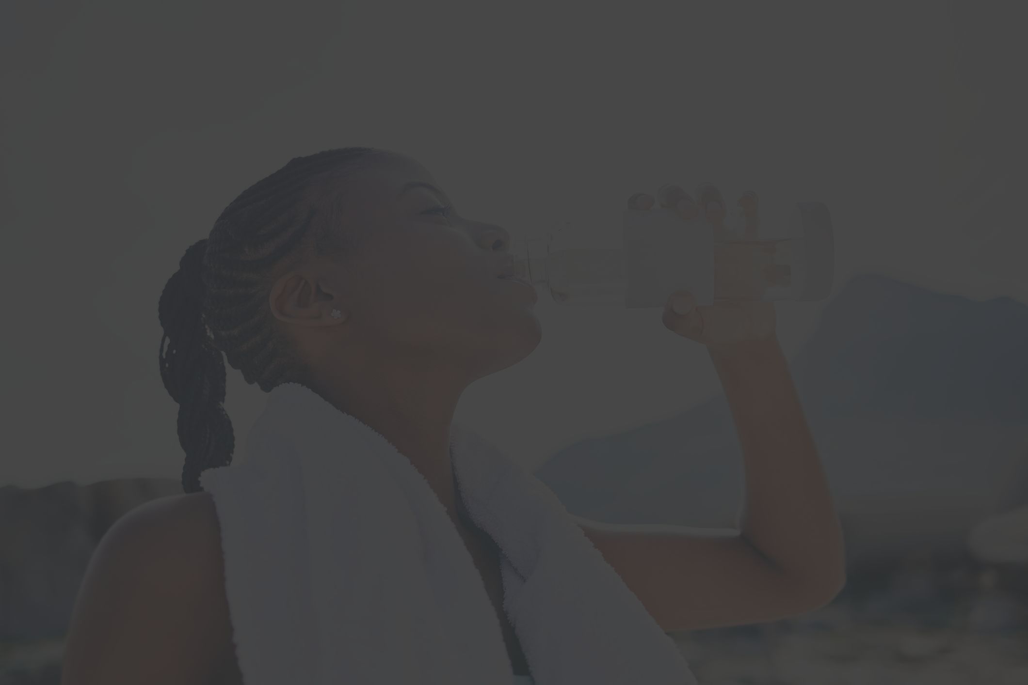 Woman drinking from bottle of water