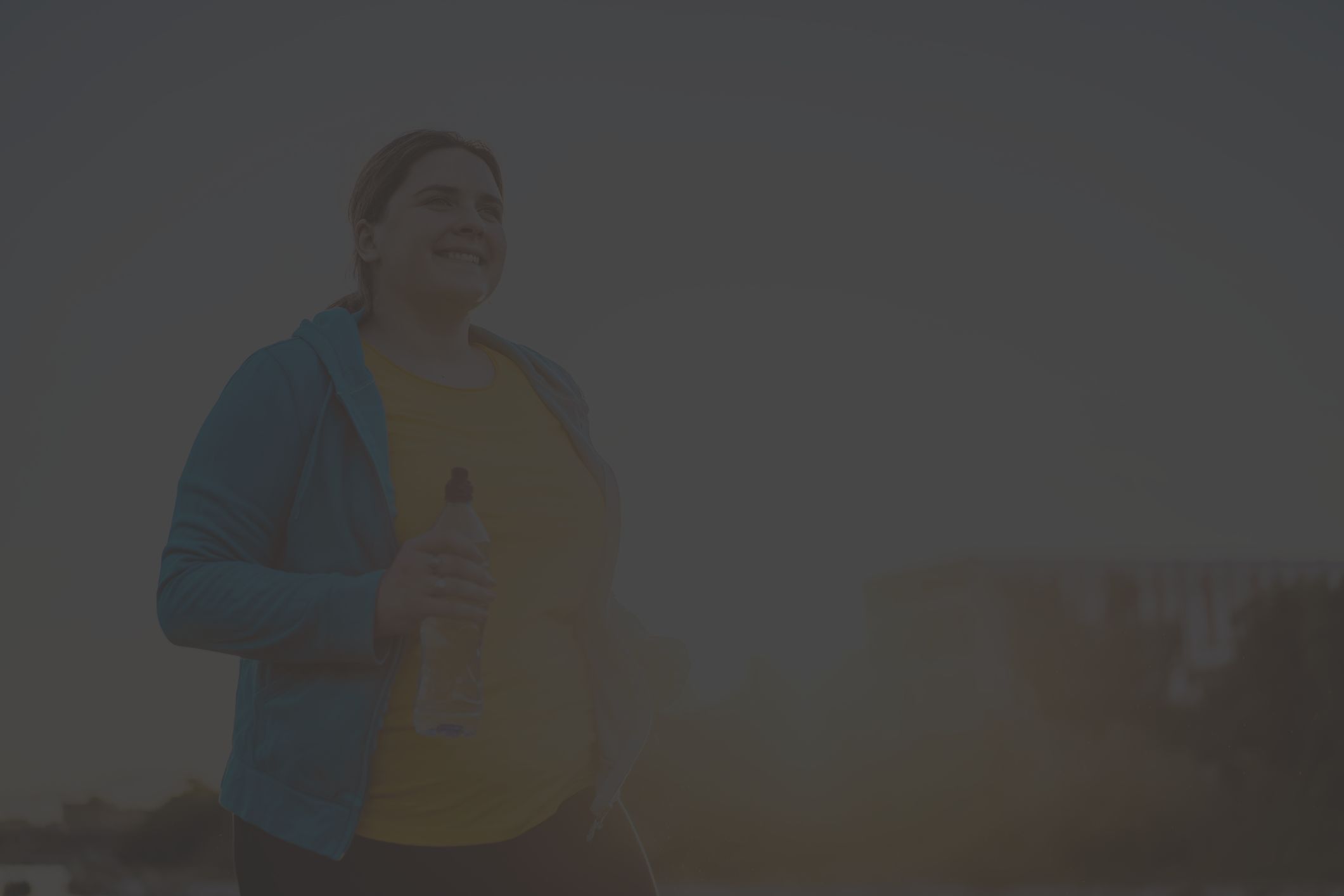 Happy curvy african woman doing workout routine outdoor at city park