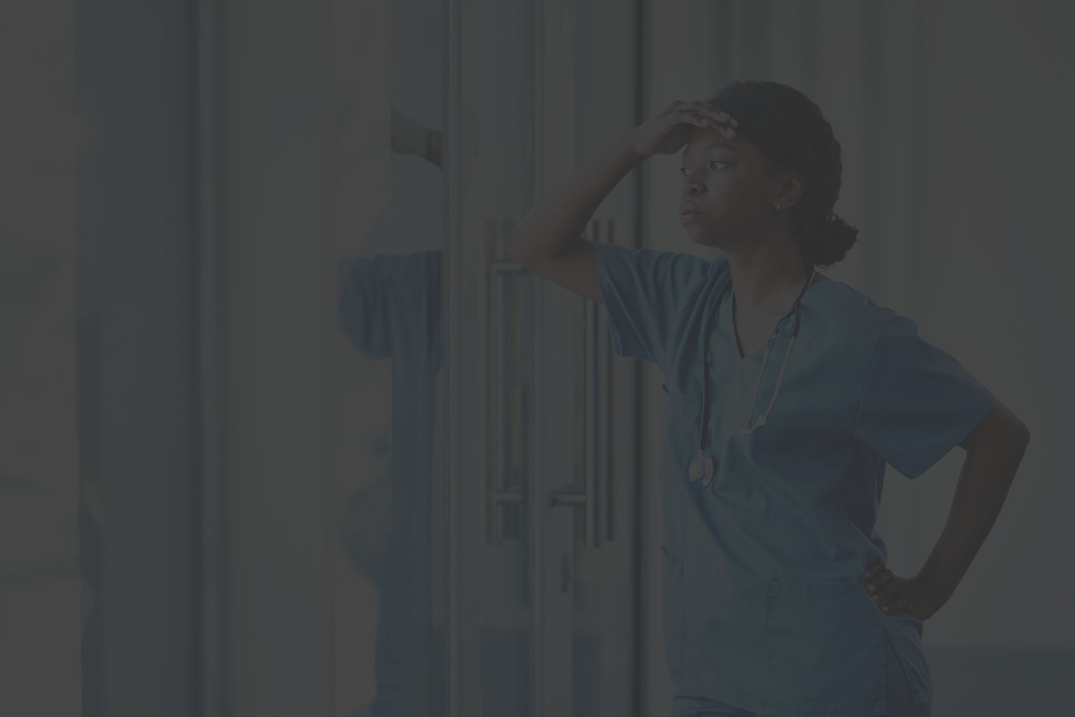frustrated nurse leaning on window