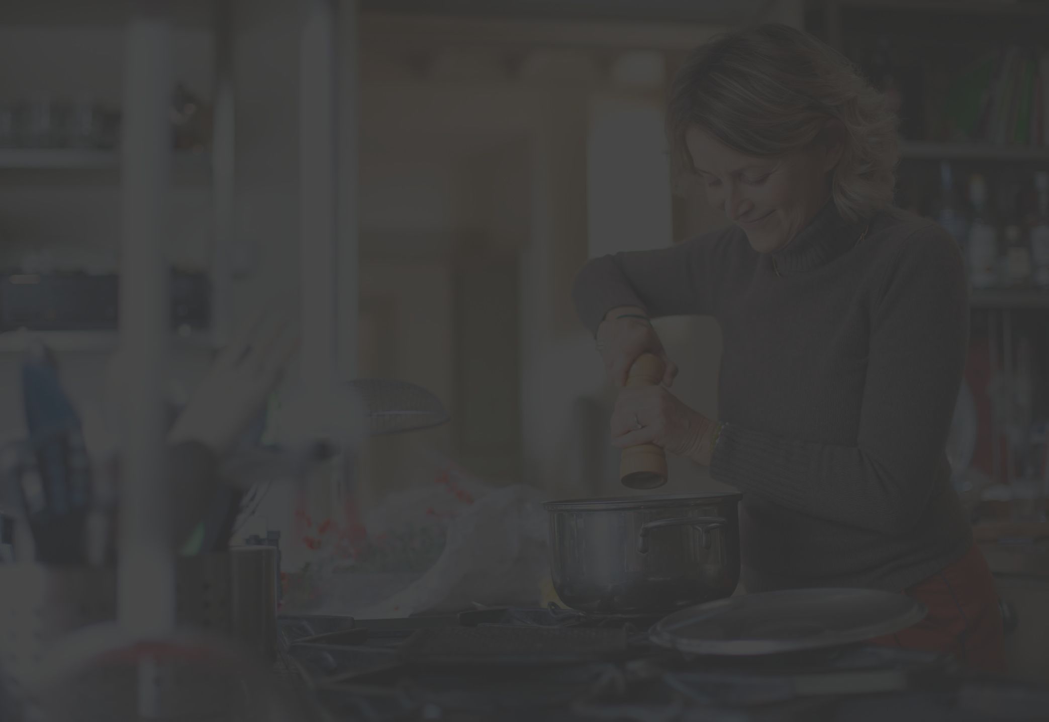 middle-aged woman cooking in home kitchen