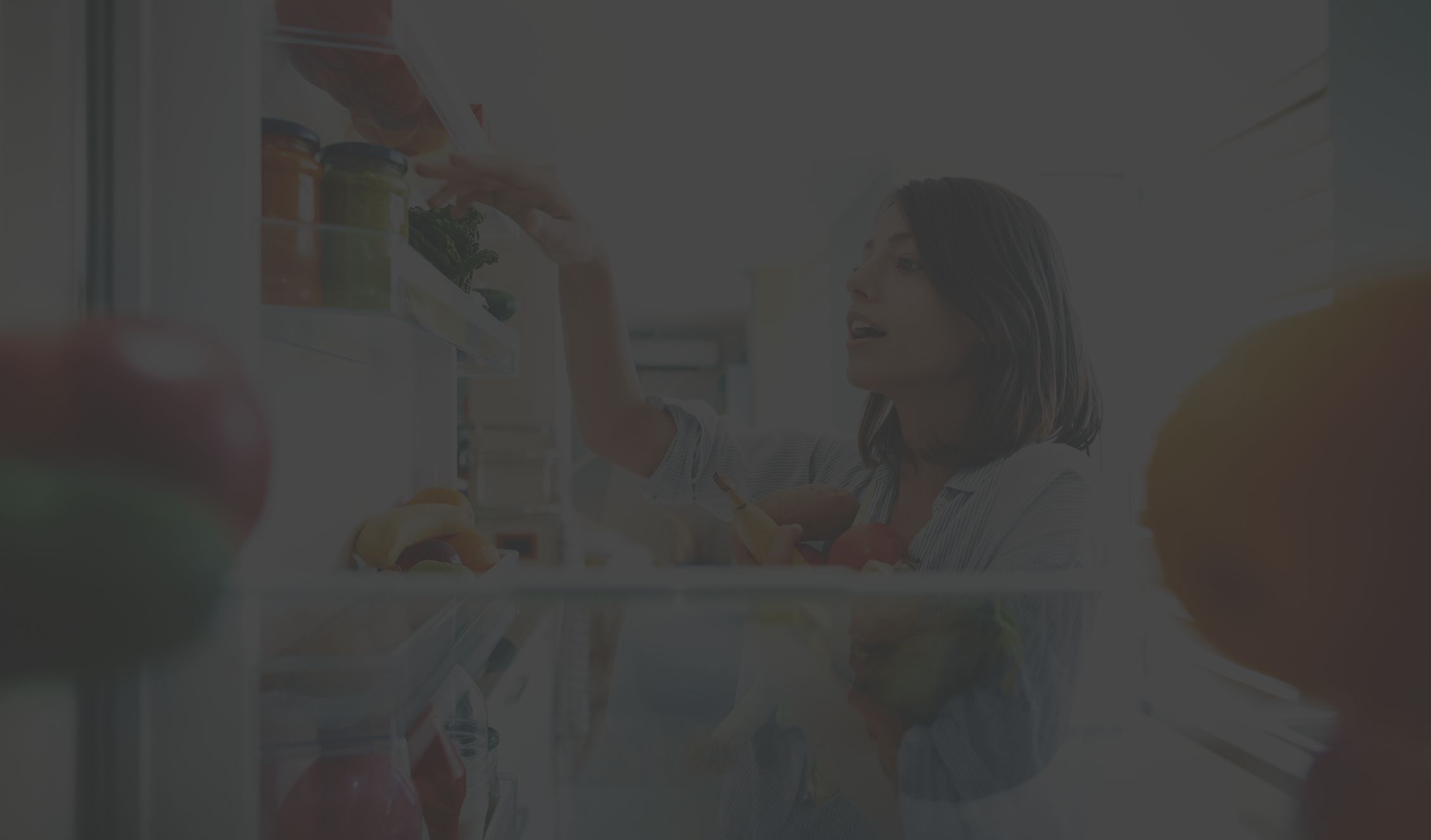 woman looking in refrigerator