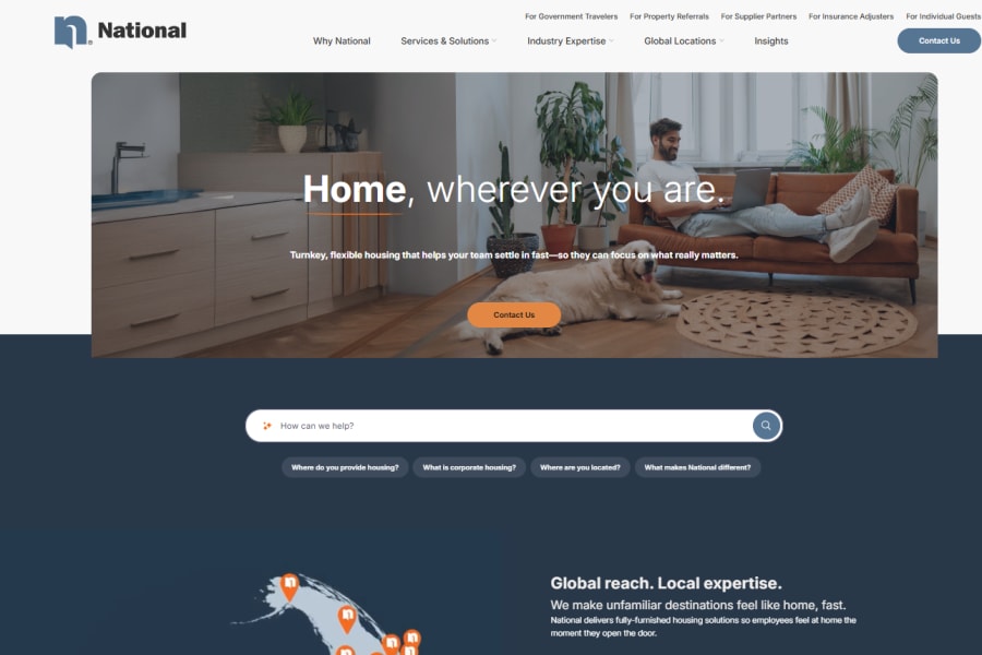 A website homepage for National, featuring a man on a sofa with a laptop and a golden retriever.