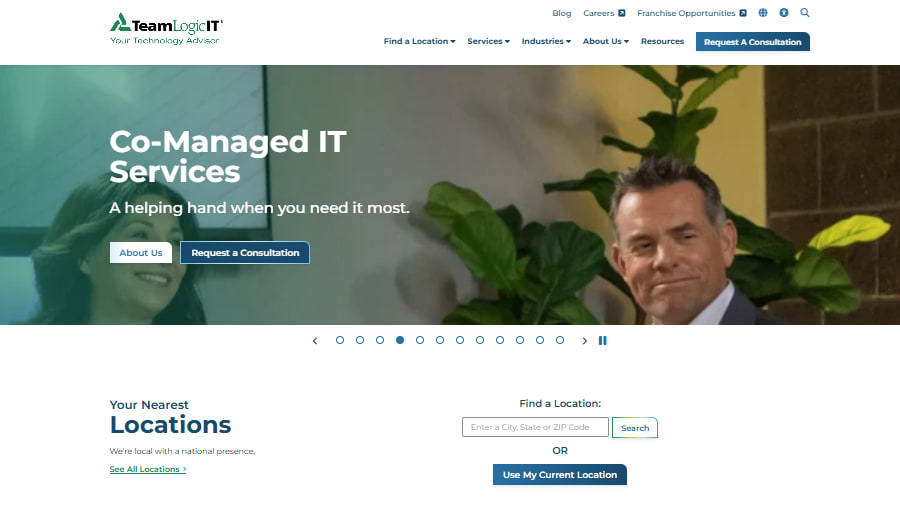 A website banner for TeamLogic IT, featuring a woman and a man with text "Co-Managed IT Services."